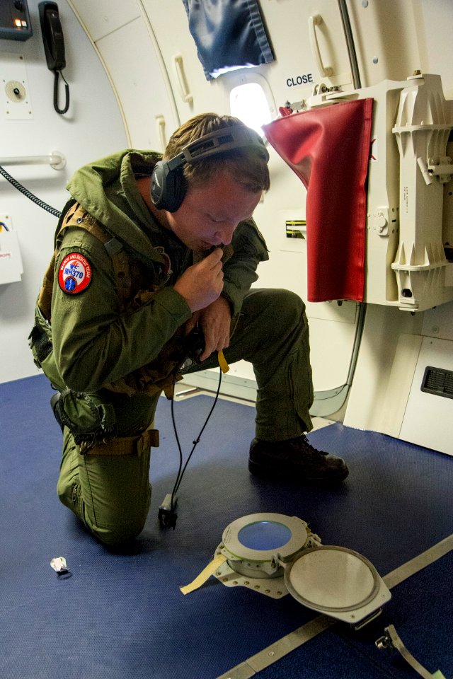 U.S. Navy Naval Aircrewman (Operator) 2nd Class Clark Urbin, assigned to Patrol Squadron (VP) 16, relays to flight crew members aboard a P-8A Poseidon aircraft flying over the Indian Ocean April 15, 2014, that 140415-N-VD564-050