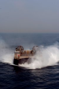 U.S. Navy Landing Craft, Air Cushion 9, assigned to Naval Beach Unit 7, prepares to enter the well deck of the amphibious assault ship USS Bonhomme Richard (LHD 6) in the East China Sea during Ssang Yong 14 as 140402-N-LM312-012