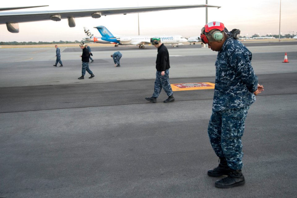 U.S. Navy maintenance crew members assigned to Patrol Squadron (VP) 16 conduct a foreign object debris walk down around a P-8A Poseidon aircraft at Perth Airport in Perth, Australia, April 4, 2014 140404-N-VD564-006