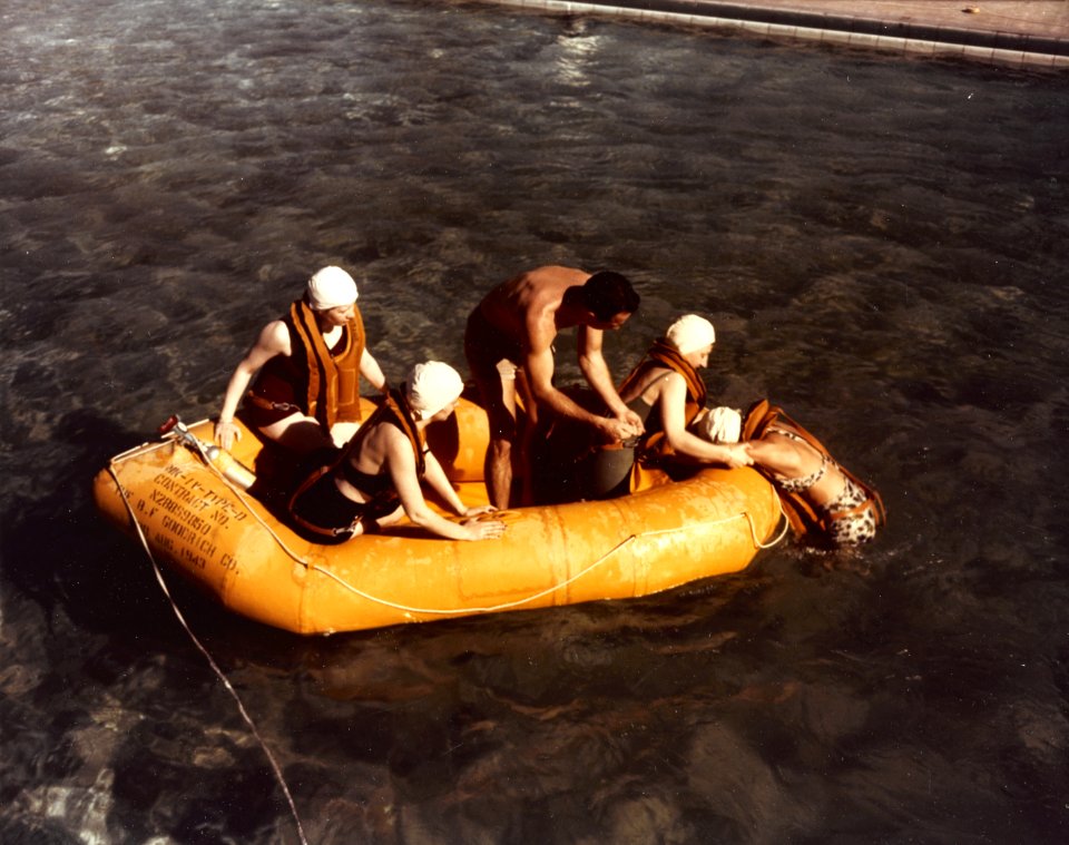 U.S. Navy Flight Nurses practice how to get an unconscious person into a life raft, in 1944-1945 (80-G-K-2820)