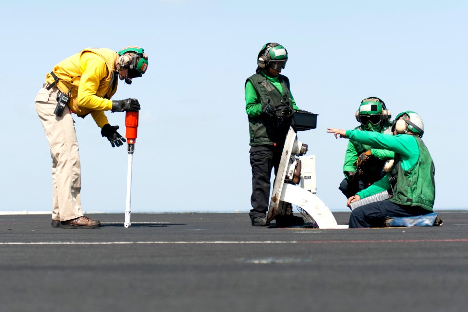 U.S. Navy Lt. Andrew Tingley, left, Aviation Boatswain's Mate (Equipment) Airman Monique Carmona, center, and Aviation Boatswain's Mates (Equipment) 3rd Class Roberto Roque and Tylan Remata perform catapult 140219-N-ZG705-486