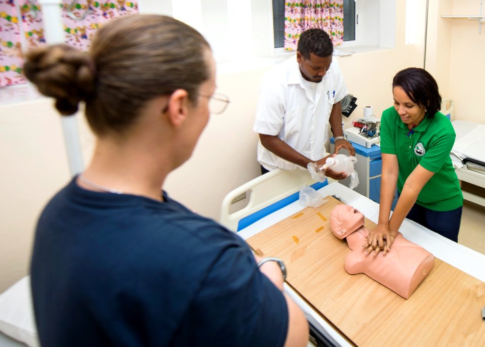 U.S. Navy Lt. Cmdr. Suzanne Maldarelli, left, a medical officer, conducts a subject matter expert exchange on advanced cardiac life support with nurses at a hospital in Toledo, Belize, June 27, 2014, during 140627-N-XQ474-055