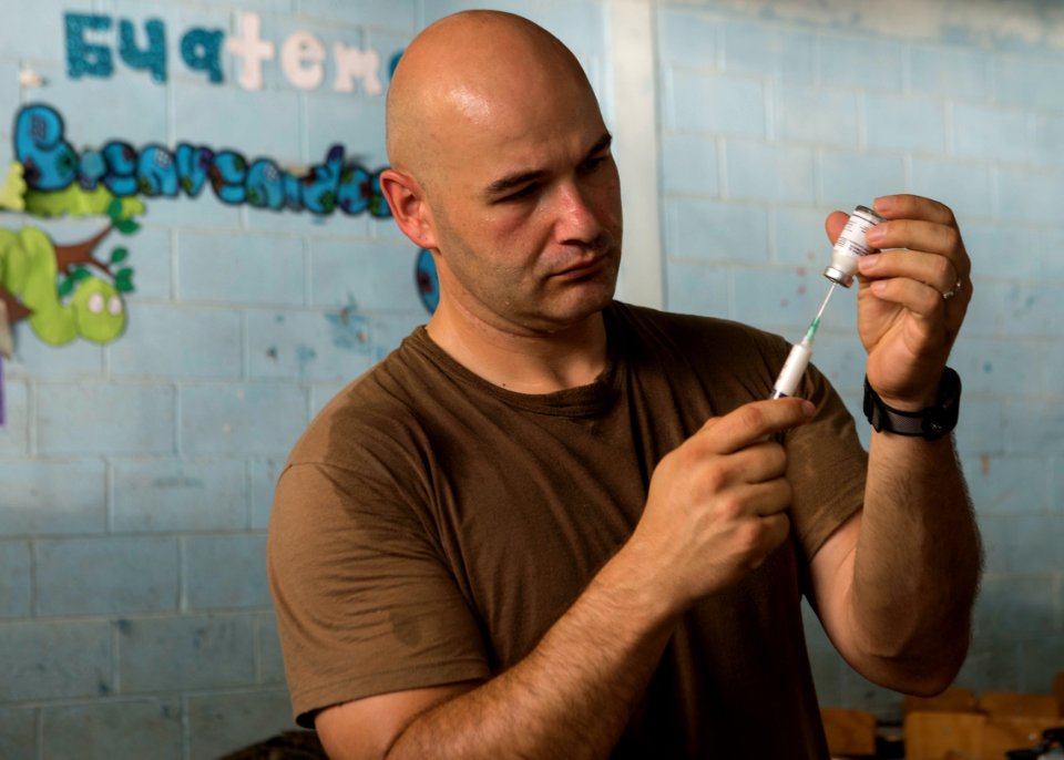 U.S. Navy Lt. Cmdr. Tim Whiting, a medical officer, prepares medication at a medical civic action project (MEDCAP) in Puerto Barrios, Guatemala, Aug. 23, 2014, during Southern Partnership Station (SPS) 2014 140823-N-QY430-083