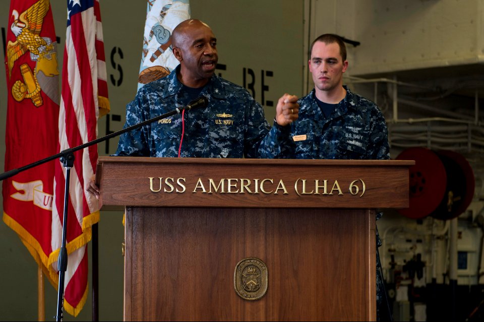 U.S. Navy Rear Adm. Frank L. Ponds, left, the commander of Expeditionary Strike Group 3, gives closing remarks during a 9-11 remembrance ceremony in the hangar bay aboard the newly commissioned amphibious 140911-N-MD297-132