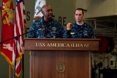 U.S. Navy Rear Adm. Frank L. Ponds, left, the commander of Expeditionary Strike Group 3, gives closing remarks during a 9-11 remembrance ceremony in the hangar bay aboard the newly commissioned amphibious 140911-N-MD297-132