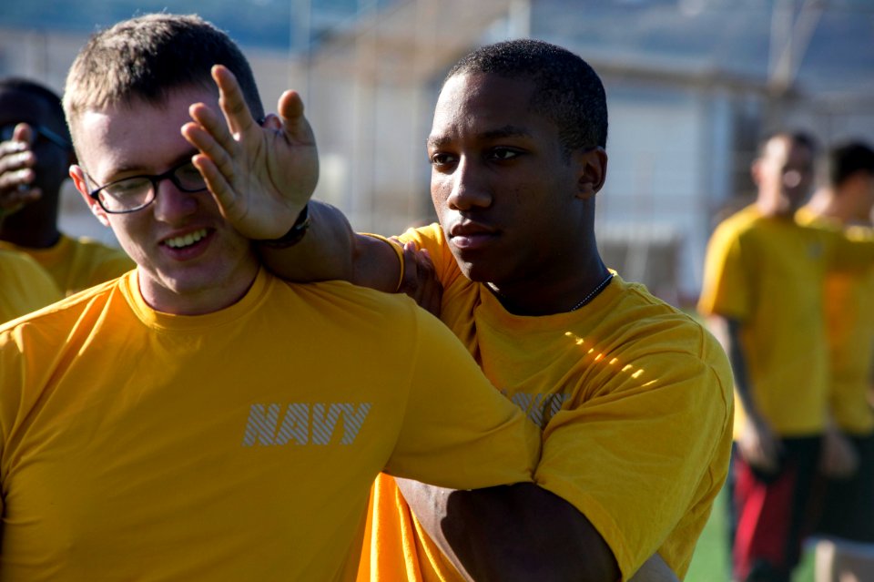 U.S. Navy Information Systems Technician Seamen Krel Jensen, left, and Maurice Jones, both assigned to the guided missile destroyer USS Ramage (DDG 61), practice defending against and subduing an attacker 131122-N-VC236-016