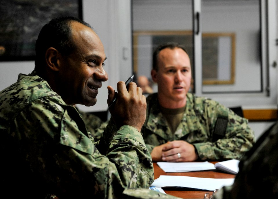 U.S. Navy Rear Adm. Vincent Griffith, left, the commander of Naval Supply Systems Command, Global Logistics Support, attends a briefing on Camp Lemonnier logistics operations during a tour of the camp 140115-N-LE393-151