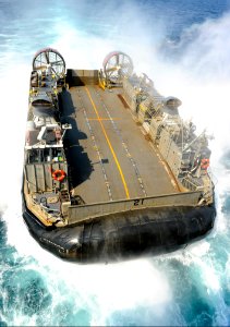 U.S. Navy Landing Craft, Air Cushion 21, assigned to Naval Beach Unit 7, approaches the well deck of the amphibious assault ship USS Bonhomme Richard (LHD 6), not pictured, in the East China Sea April 5, 2014 140405-N-LM312-035
