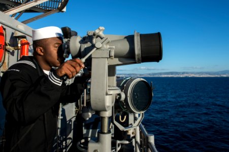 U.S. Navy Seaman Recruit Martin Miles stands lookout watch aboard the guided missile cruiser USS Philippine Sea (CG 58) as it moors in Piraeus, Greece, for a scheduled liberty port visit March 4, 2014 140304-N-PJ969-117