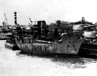 U.S. Navy sludge removal barge YSR-42 alongside of USS Oklahoma (BB-37) at Pearl Harbor, circa in 1944