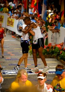 U.S. Navy Special Warfare Operator 1st Class (SEAL) David Goggins, right, assigned to Naval Special Warfare Center, embraces Cmdr. Keith Davids, commanding officer of SEAL Team One, as they cross the finish line 081011-N-BV344-004 photo