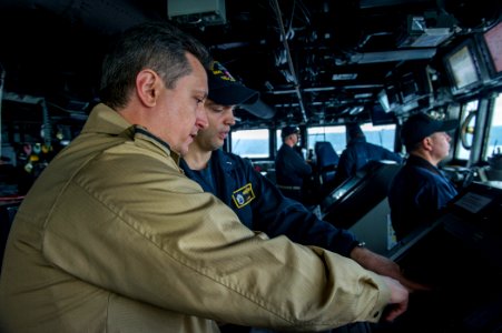 U.S. Navy Lt. j.g. Joseph Testa, second from left, works alongside Romanian Naval Forces Warrant Officer Daniel Pap aboard the guided missile destroyer USS Truxtun (DDG 103) in the Bosphorus strait March 7 140307-N-EI510-011