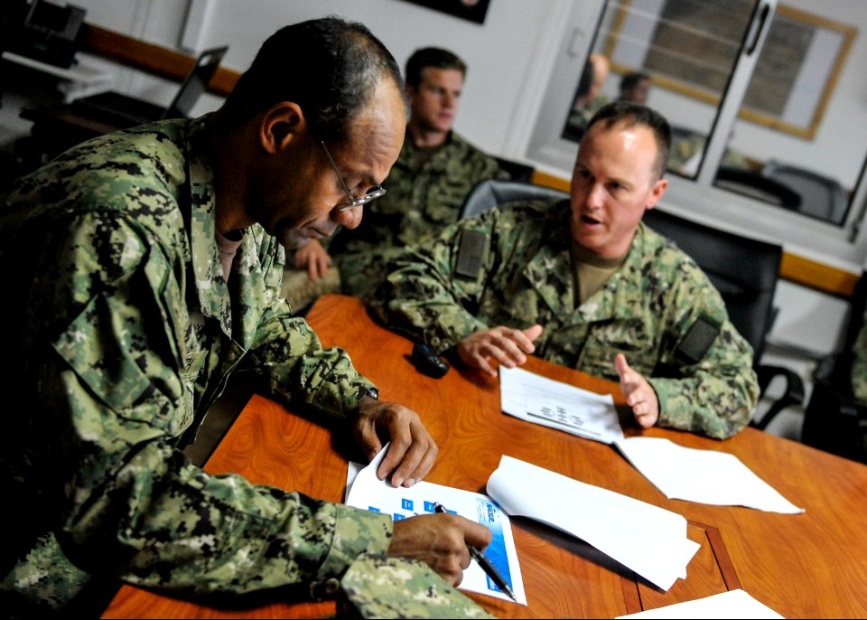 U.S. Navy Lt. Cmdr. Kelly House, right, a supply officer, briefs Rear Adm. Vincent Griffith, the commander of Naval Supply Systems Command, Global Logistics Support, on camp logistics operations during a tour 140115-N-LE393-143