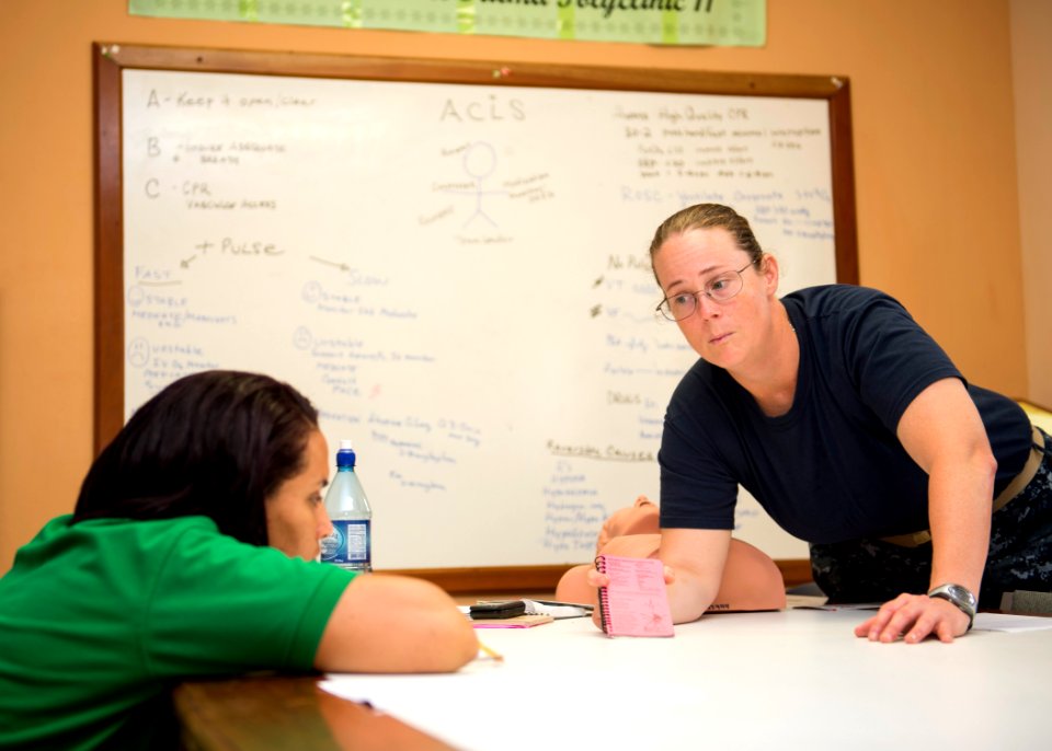 U.S. Navy Lt. Cmdr. Suzanne Maldarelli, right, a medical officer, conducts a subject matter expert exchange on advanced cardiac life support with Lissette Recinos, a public health nurse, at a hospital in Toledo 140627-N-XQ474-030
