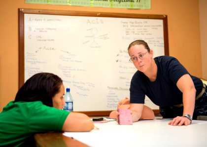 U.S. Navy Lt. Cmdr. Suzanne Maldarelli, right, a medical officer, conducts a subject matter expert exchange on advanced cardiac life support with Lissette Recinos, a public health nurse, at a hospital in Toledo 140627-N-XQ474-030