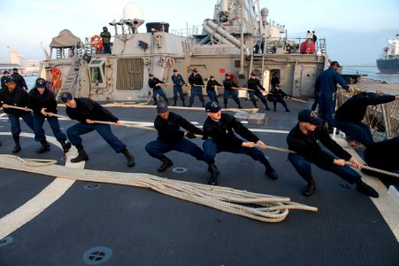 U.S. Sailors aboard the guided missile destroyer USS Stout (DDG 55) heave mooring lines as the ship pulls into port in Haifa, Israel, Jan. 19, 2014, for a scheduled port visit 140119-N-UD469-425
