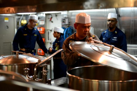 U.S. Sailors accompany a member of the Board of Inspection and Survey (INSURV) as he evaluates the galley aboard the amphibious transport dock ship USS Mesa Verde (LPD 19) Jan. 16, 2014, in the Atlantic Ocean 140116-N-BD629-357