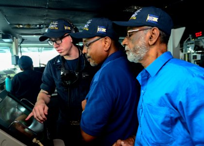 U.S. Navy Operations Specialist 3rd Class Caleb Leger explains a bridge watch to distinguished visitors aboard the aircraft carrier USS Nimitz (CVN 68)during exercise Malabar 2017 photo