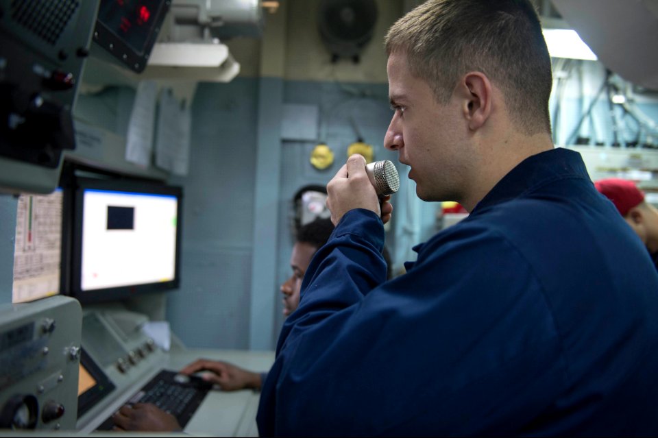 U.S. Navy Damage Controlman 2nd Class Wesley White announces engineering casualties during a basic engineering casualty control exercise Jan. 15, 2014, in the central control station of the guided missile 140115-N-UD469-345