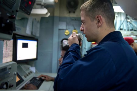 U.S. Navy Damage Controlman 2nd Class Wesley White announces engineering casualties during a basic engineering casualty control exercise Jan. 15, 2014, in the central control station of the guided missile 140115-N-UD469-345