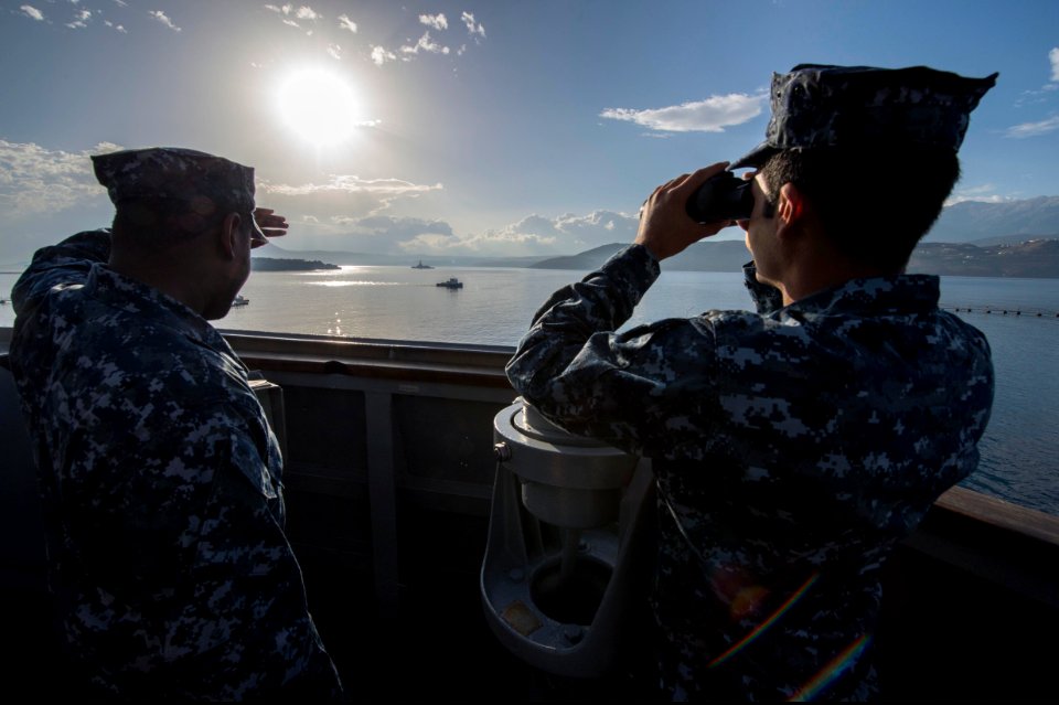 U.S. Navy Lt. j.g. Zishan Hameed, right, and Interior Communications Electrician 2nd Class Malcolm Newkirk monitor a Spanish frigate while standing watch aboard the guided missile destroyer USS Ramage (DDG 61) 131120-N-VC236-005