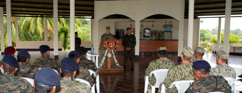 U.S. Navy Lt. Sean Tucker, at lectern, attached to Coastal Riverine Squadron (CORIVRON) 2, speaks to U.S. and Guatemalan personnel as part of their closing ceremony in Puerto Barrios, Guatemala, Aug. 21, 2014 140821-N-QY430-035