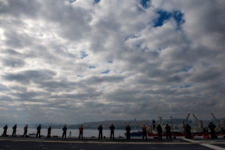 U.S. Sailors and Marines man the rails as the amphibious assault ship USS America (LHA 6) leaves Valparaiso, Chile, Aug. 27, 2014 140827-N-MZ309-031