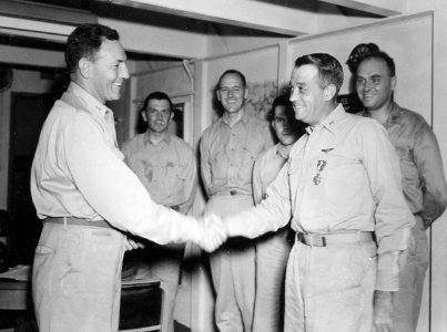 U.S. Navy Rear Admiral Calvin T. Durgin awards Rear Admiral Clifton Sprague the Navy Cross aboard USS Fanshaw Bay (CVE-70), 15 march 1945 (80-G-364246)