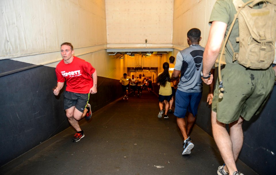 U.S. Sailors and Marines commemorate the Bataan Death March by running 63 laps up and down the ramp from the hangar bay to the flight deck aboard the amphibious assault ship USS Bataan (LHD 5) in the Gulf 140409-N-MW280-013