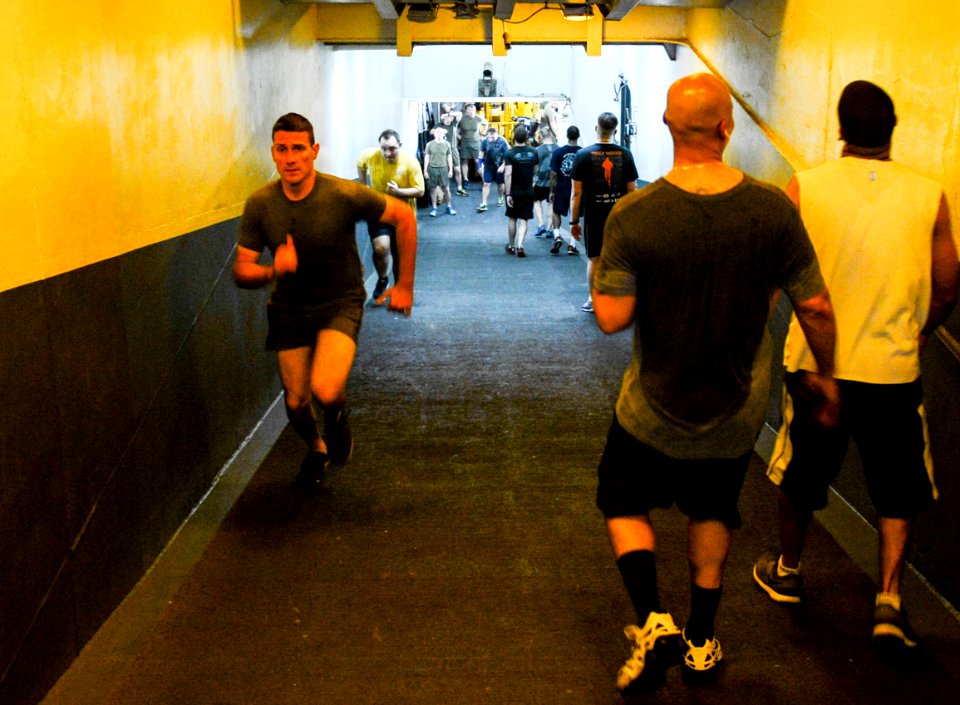 U.S. Sailors and Marines commemorate the Bataan Death March by running 63 laps up and down the ramp from the hangar bay to the flight deck aboard the amphibious assault ship USS Bataan (LHD 5) in the Gulf 140409-N-MW280-181