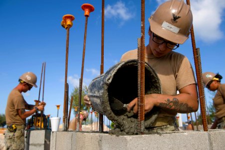 U.S. Navy Sailor pours concrete during construction. (39070110124)