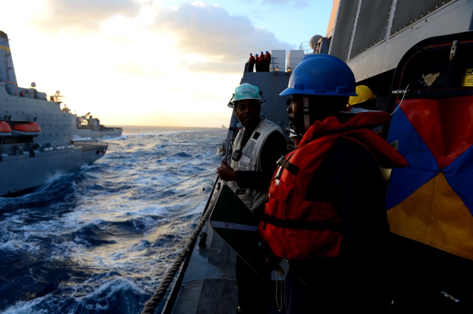 U.S. Sailors aboard the amphibious transport dock ship USS Mesa Verde (LPD 19), right, prepare for a replenishment at sea with the fleet replenishment oiler USNS John Lenthall (T-AO 189) in the Mediterranean Sea 140312-N-BD629-039