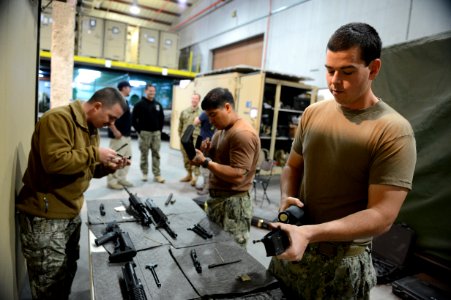 U.S. Navy Mineman 1st Class Thomas Harrell, right, assigned to Commander, Task Force (CTF) 56, reassembles an M4 carbine during weapons training at Naval Support Activity Bahrain in Manama, Bahrain, Feb. 12 140212-N-OU681-163