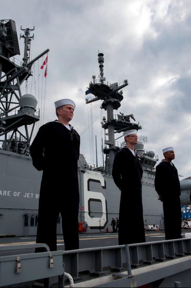 U.S. Sailors assigned to the amphibious assault ship USS America (LHA 6) man the rails as the ship leaves Valparaiso, Chile, Aug. 27, 2014 140827-N-MZ309-015