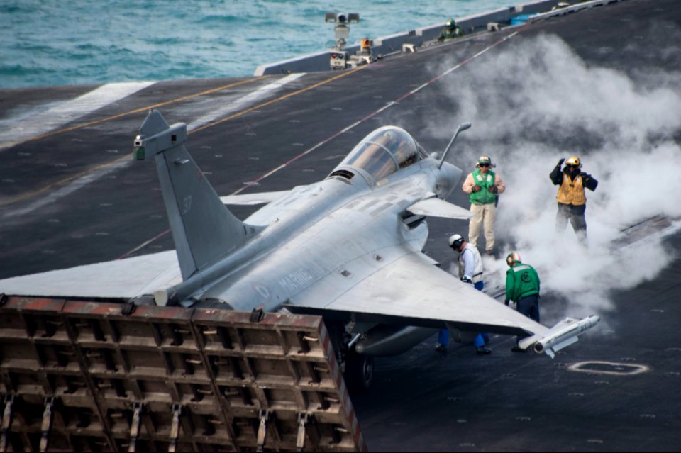 U.S. Sailors prepare a French navy F1 Rafale aircraft assigned to the aircraft carrier Charles de Gaulle to launch from the aircraft carrier USS Harry S. Truman (CVN 75) during carrier qualification integration 140113-N-ZG705-373