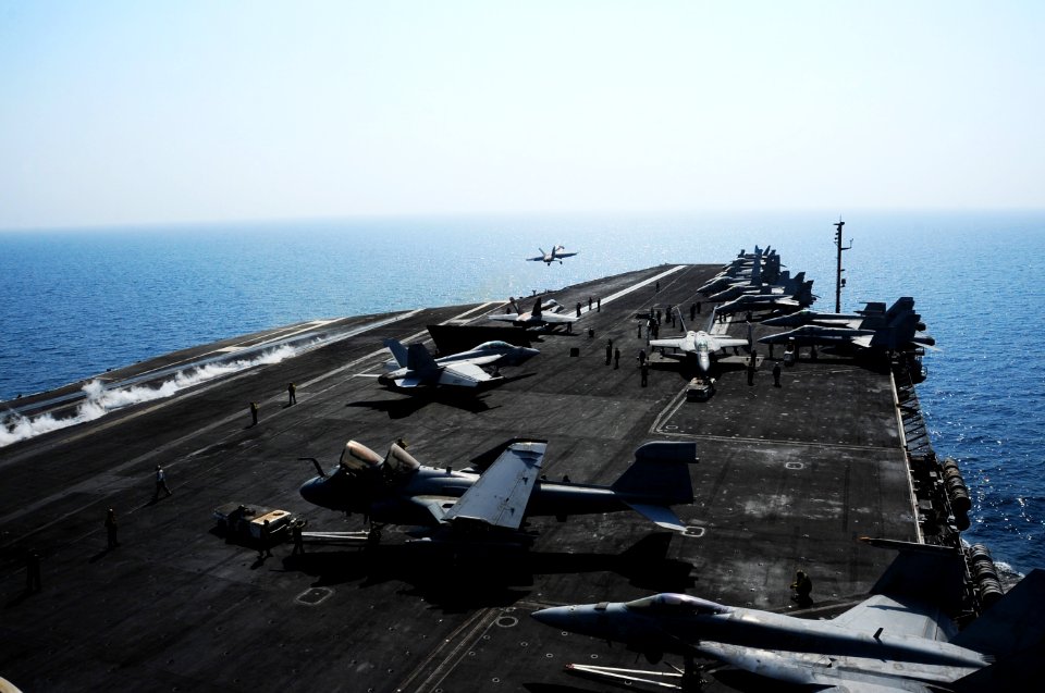 U.S. Sailors move an EA-6B Prowler aircraft, second from front, assigned to Electronic Attack Squadron (VAQ) 134, while aircraft prepare to take off from the flight deck of the aircraft carrier USS George H.W 140826-N-CZ979-009