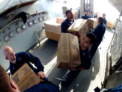 U.S. Sailors aboard the guided missile destroyer USS Ramage (DDG 61) move supplies during a replenishment at sea in the Mediterranean Sea Feb. 22, 2014 140222-N-CH661-202