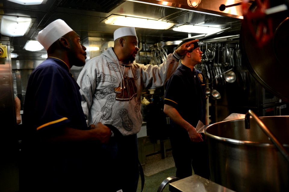 U.S. Sailors accompany a civilian member of the Board of Inspection and Survey (INSURV) as he evaluates the galley aboard the amphibious transport dock ship USS Mesa Verde (LPD 19) Jan. 16, 2014, in the Atlantic 140116-N-BD629-156