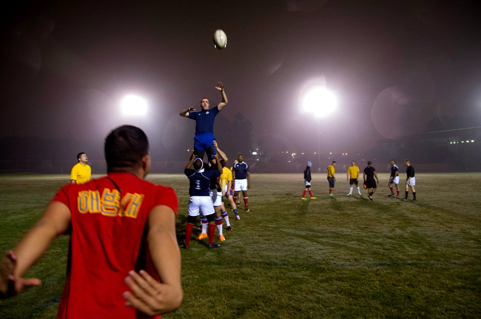 U.S. Sailors and Marines assigned to the amphibious assault ship USS America (LHA 6) and Peruvian sailors play rugby in Callao, Peru, Sept 140901-N-MZ309-083