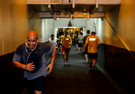 U.S. Sailors and Marines commemorate the Bataan Death March by running 63 laps up and down the ramp from the hangar bay to the flight deck aboard the amphibious assault ship USS Bataan (LHD 5) in the Gulf 140409-N-MW280-101