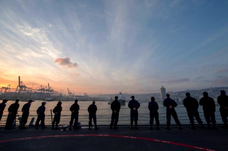 U.S. Sailors man the rails aboard the guided missile destroyer USS Stout (DDG 55) as the ship pulls into port in Haifa, Israel, Jan. 19, 2014, for a scheduled port visit 140119-N-UD469-321