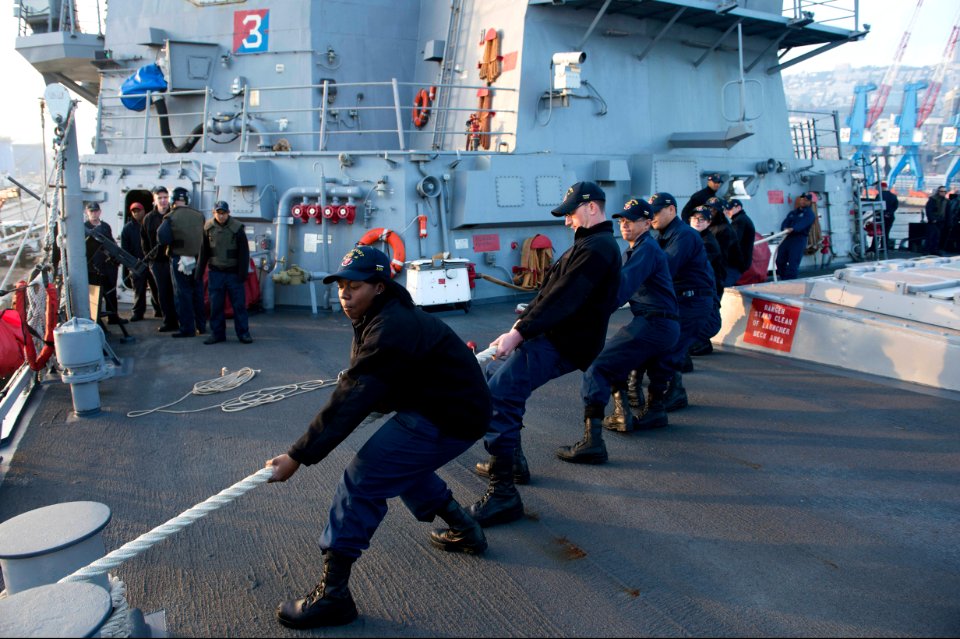 U.S. Sailors aboard the guided missile destroyer USS Stout (DDG 55) heave mooring lines as the ship pulls into port in Haifa, Israel, Jan. 19, 2014, for a scheduled port visit 140119-N-UD469-520