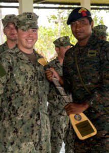 U.S. Navy Lt. Sean Tucker, left foreground, attached to Coastal Riverine Squadron (CORIVRON) 2, gives an appreciation gift to a Guatemalan service member as part of their closing ceremony in Puerto Barrios 140821-N-QY430-086