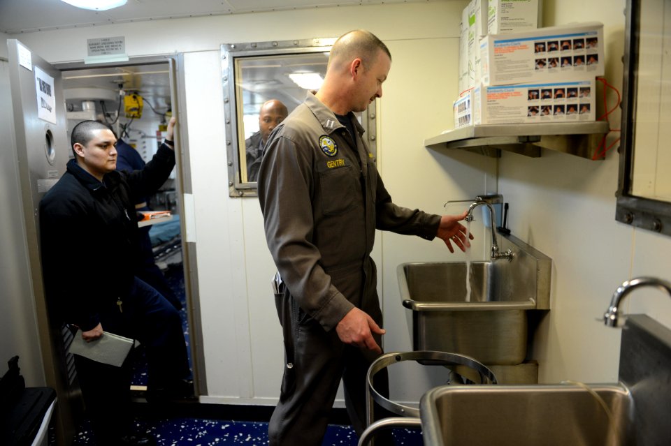 U.S. Sailors accompany a member of the Board of Inspection and Survey (INSURV) as he evaluates their work area aboard the amphibious transport dock ship USS Mesa Verde (LPD 19) Jan. 16, 2014, in the Atlantic 140116-N-BD629-003