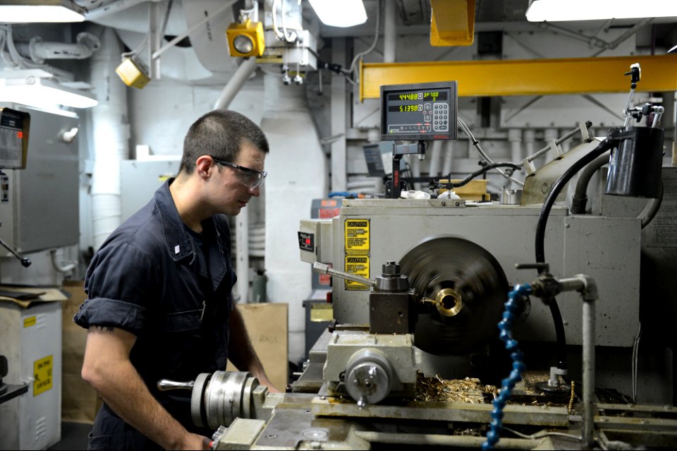 U.S. Navy Machinery Repairman Fireman Timothy Grover works on the amphibious assault ship USS Bataan (LHD 5) in the U.S. 5th Fleet area of responsibility June 28, 2014 140628-N-MW280-011