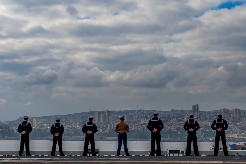U.S. Sailors and Marines man the rails as the amphibious assault ship USS America (LHA 6) leaves Valparaiso, Chile, Aug. 27, 2014 140827-N-MZ309-042
