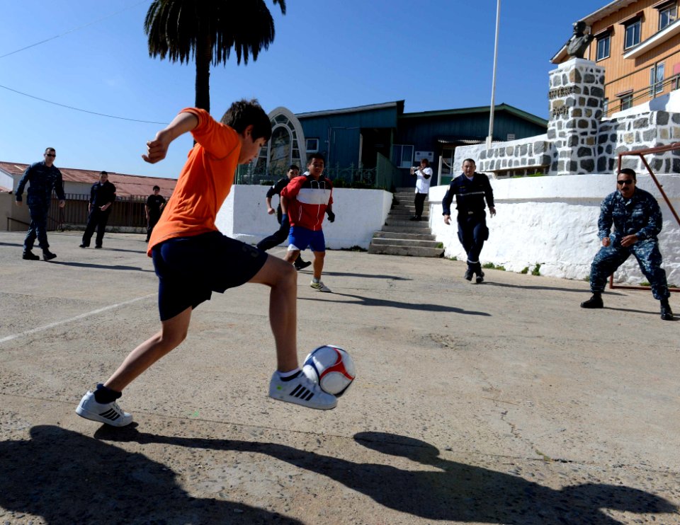 U.S. Sailors assigned to the amphibious assault ship USS America (LHA 6) and Chilean sailors play soccer with children during a community service project in Valparaiso, Chile, Aug. 26, 2014 140826-N-MZ309-044