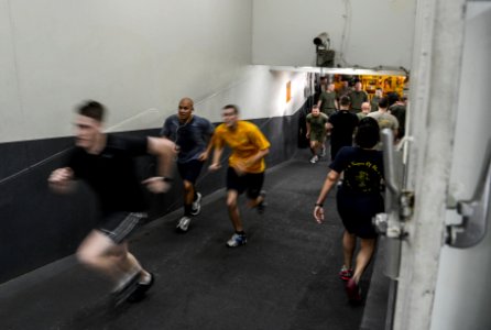 U.S. Sailors and Marines commemorate the Bataan Death March by running 63 laps up and down the ramp from the hangar bay to the flight deck aboard the amphibious assault ship USS Bataan (LHD 5) in the Gulf 140409-N-MW280-088