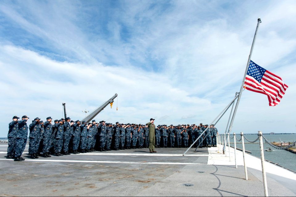 U.S. Sailors assigned to the aircraft carrier USS Harry S. Truman (CVN 75) salute the U.S. flag during a 9-11 remembrance ceremony at Naval Station Norfolk, Va., Sept 140911-N-ZG705-066