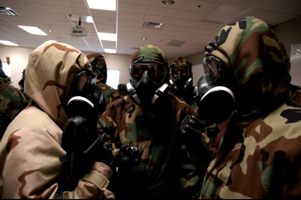 U.S. Sailors with Naval Mobile Construction Battalion (NMCB) 25 review procedures before testing the outside air quality during a simulated chemical attack during chemical, biological and radiological (CBR) team 140214-N-JP566-094